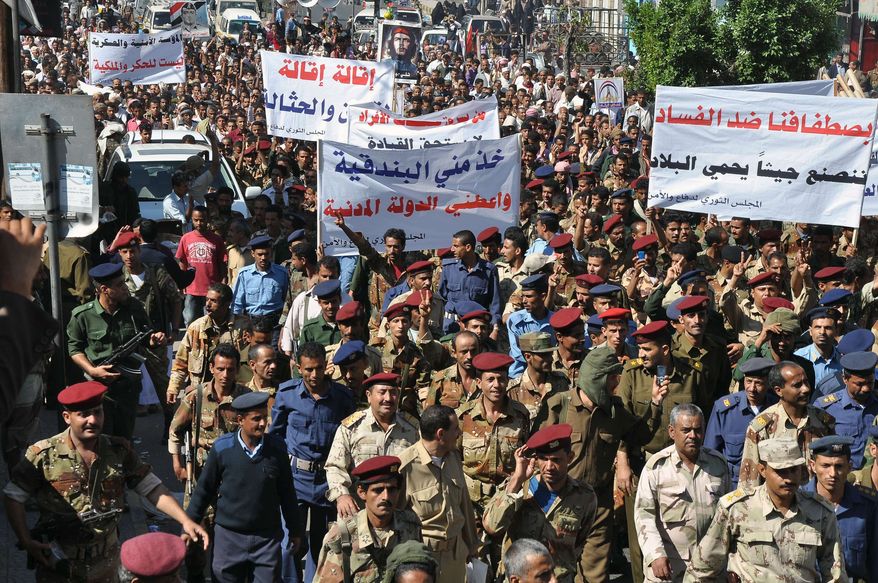Yemeni soldiers and officers march during a rally demanding reforms and dismissal of a senior official over alleged corruption in Taiz, Yemen, Saturday, Dec. 31, 2011. (AP Photo/Anees Mahyoub)