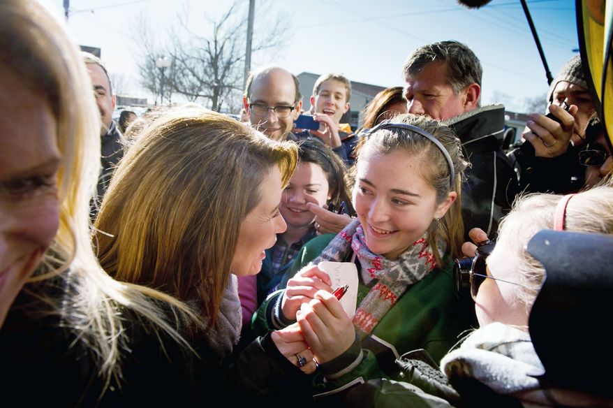After a campaign stop at Paula's Maid Rite Restaurant in West Des Moines, Iowa, on Monday, Michele Bachmann greets Advanced Placement government and history students from Taylor High School of Cincinnati, Ohio. Mrs. Bachmann's husband, Marcus, is at right. (Andrew Harnik/The Washington Times)
