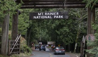 The west entrance to Mount Rainier National Park in Washington state is seen on Jan. 1, 2012. State patrol troopers were checking outgoing cars and park rangers were turning away visitors after a National Park Service ranger was shot and killed that morning. (Associated Press)