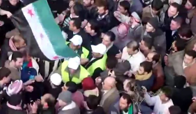 In this image from amateur video, Arab League observers are seen Dec. 30, 2011, at a protest in Idlib, Syria. Hundreds of thousands of Syrians poured into the streets across the nation in the largest protests in months, shouting for the downfall of the regime in a defiant display invigorated by the presence of Arab observers, activists said. (Associated Press/Shaam News Network via APTN)