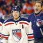 New York Rangers coach John Tortorella, right, argues a penalty call as Ruslan Fedotenko, left, and Brad Richards look on late in the third period of the NHL Winter Classic game against the Philadelphia Flyers, Monday, Jan. 2, 2012, in Philadelphia. New York won 3-2. (AP Photo/Tom Mihalek)