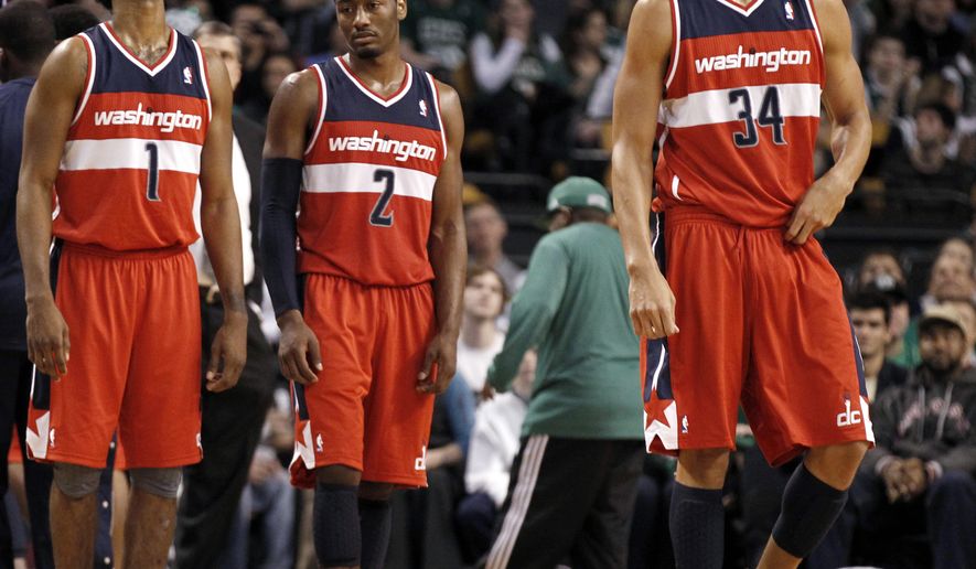 Washington Wizards&#39; Nick Young (1), John Wall (2) and JaVale McGee wait for play to resume during the fourth quarter of the Wizards&#39; 100-92 loss to the Boston Celtics in an NBA game in Boston Monday, Jan. 2, 2012. (AP Photo/Winslow Townson)