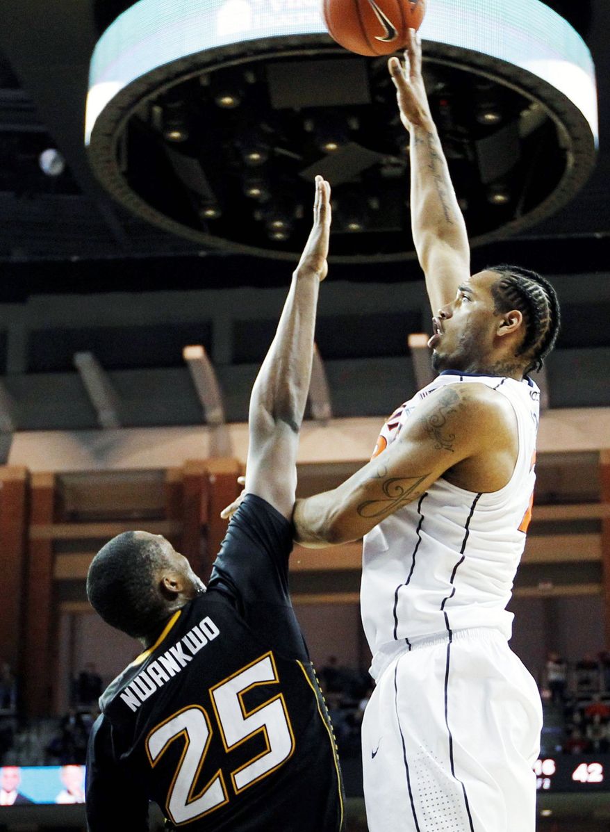 Robert Nwankwo (left) and Towson came close at Virginia on Friday, but the Tigers fell 57-50. It was their 13th of 14 losses this season. (Associated Press)