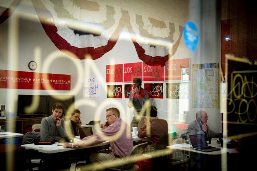 Volunteers for Republican presidential candidate Jon Huntsman work the phones at Huntsman's New Hampshire campaign headquarters in Manchester, NH, Tuesday, January 3, 2012. (Rod Lamkey Jr/ The Washington Times)