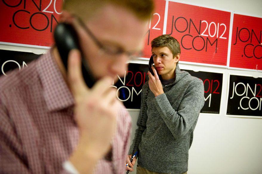 James Linville (right) of New York, NY, and Jake Wagner (left) of Manchester, NH, volunteers for Republican presidential candidate Jon Huntsman, work the phones at Huntsman's New Hampshire campaign headquarters. (Rod Lamkey Jr/ The Washington Times)