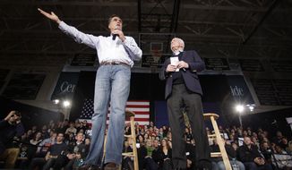 Republican presidential candidate and former Massachusetts Gov. Mitt Romney (left), accompanied by Sen. John McCain, Arizona Republican, campaigns Jan. 4, 2012, during a town hall style meeting in Manchester, N.H. (Associated Press)