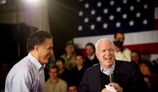 Former Massachusetts Gov. Mitt Romney and Sen. John McCain share a laugh at a town-hall meeting at Manchester Central High School in Manchester, N.H., on Wednesday, Jan. 4, 2012. (Rod Lamkey Jr./The Washington Times)