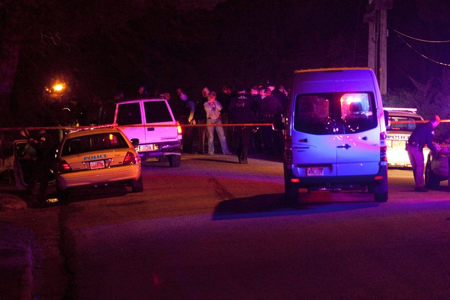 Police officers and emergency crew are seen Jan. 4, 2012, near 3268 Jackson Street in Ogden, Utah, where 6 police officers were shot, including those from the Weber-Morgan Narcotics Strike Force and the Ogden Police Department, while serving a warrant. The suspect was also shot. (Associated Press/Standard-Examiner)