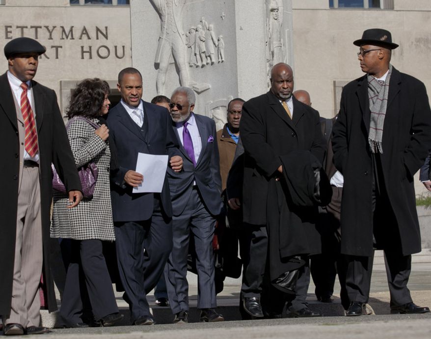 Former D.C. Council member Harry Thomas Jr., 51, and his family exit the U.S. District Courthouse in D.C., on Jan. 6, 2012, after Thomas pleaded guilty to felony counts of stealing more than $350,000 in taxpayer funds and failing to report income on his tax returns. (Andrew S. Geraci/The Washington Times)