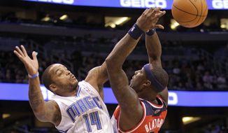 Orlando Magic guard Jameer Nelson (14) fouls Washington Wizards forward Andray Blatche as he tries to block a shot during the first half of Orlando&#39;s 103-85 victory on Jan. 4, 2012, in Orlando, Fla. (Associated Press)