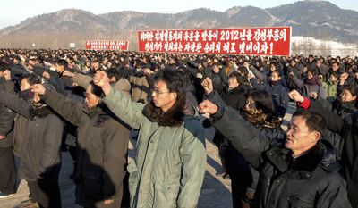 In this Jan. 6, 2012, photo released by the Korean Central News Agency and distributed in Tokyo by the Korea News Service, North Korean farmers hold a rally in support for the country&#39;s Worker&#39;s Party policies in Nampo, North Korea. (AP Photo/Korean Central News Agency via Korea News Service)