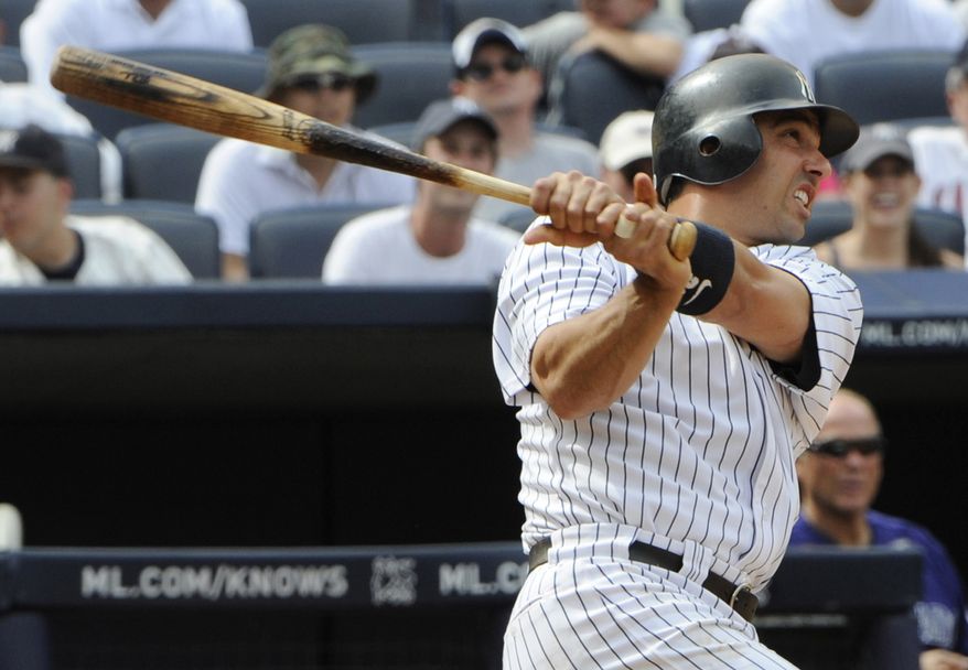 FILE - In this June 26, 2011, file photo, New York Yankees' Jorge Posada hits a home run during the fifth inning of an interleague baseball game against the Colorado Rockies at Yankee Stadium in New York. A person familiar with the decision told The Associated Press on Saturday, Jan. 7, 2012, that the five-time All-Star catcher will announce his retirement this month. (AP Photo/Bill Kostroun, File)
