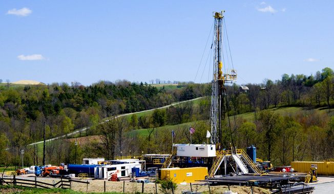 **FILE** A Chesapeake Energy natural gas well site operates near Burlington, Pa. Natural gas locked in dense rock deep beneath Pennsylvania, New York, West Virginia and Ohio requires a powerful drilling process called hydraulic fracturing, or “fracking,” to release it. (Associated Press)