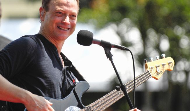 Gary Sinise performs with his Lt. Dan Band. He is working to arrange a concert to pay for a home for a Marine who lost both legs and an arm in Afghanistan. (Associated Press)