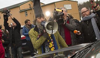 Performance artist Vermin Supreme heckles Rep. Ron Paul after Mr. Paul made a presidential campaign stop at Moe Joe&#39;s Family Restaurant in Manchester, N.H., on Monday, Jan. 9, 2012. (Rod Lamkey Jr./The Washington Times)

