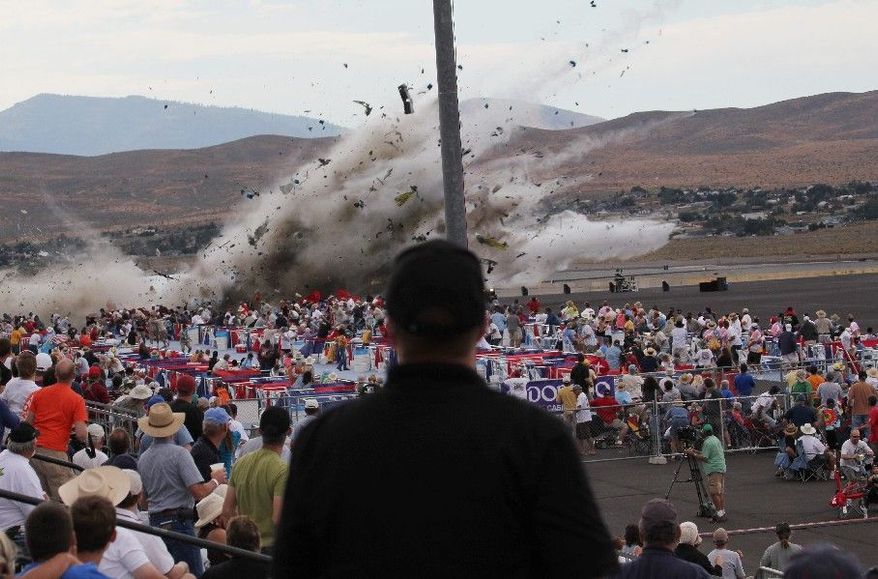 ** FILE ** Hollywood stunt pilot Jimmy Leeward's souped-up World War II-era fighter plane, a P-51 Mustang, crashes into the edge of the grandstands, sending shrapnel into the crowd, at the Reno Air Show in Reno, Nev., in September. Eleven people died and about 70 more were badly injured. (Associated Press)