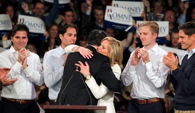 Former Massachusetts Gov. Mitt Romney hugs his wife Ann as his sons, Tagg, Craig, Ben and Josh (L-R) look on during the Romney for President New Hampshire primary night victory party at Southern New Hampshire University in Manchester, N.H., Tuesday, Jan. 10, 2012. (AP Photo/Elise Amendola)