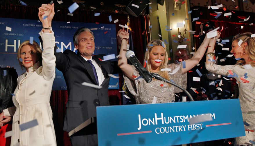 Republican presidential candidate, former Utah Gov. Jon Huntsman raises hands with his family during a New Hampshire Primary night party in Manchester, N.H., Tuesday Jan. 10, 2012. (AP Photo/Charles Krupa)