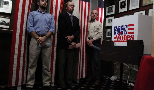 Dixville Notch, N.H., residents (from left) Tanner Tillotson, Peter Johnson and Jacques Couture wait on Monday, Jan. 9, 2012, at the Balsams Grand Resort for the stoke of midnight to cast their votes in the first-in-the-nation presidential primary. (AP Photo/Matt Rourke)