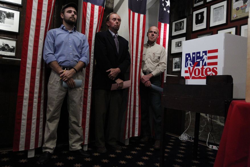 Dixville Notch, N.H., residents (from left) Tanner Tillotson, Peter Johnson and Jacques Couture wait on Monday, Jan. 9, 2012, at the Balsams Grand Resort for the stoke of midnight to cast their votes in the first-in-the-nation presidential primary. (AP Photo/Matt Rourke)