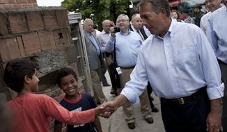 Speaker of the House Rep. John Boehner, R-Ohio, front right, shakes hands with a boy during a visit to the Vidigal slum in Rio de Janeiro, Brazil, Monday, Jan. 9, 2012. Boehner toured a Rio de Janeiro shantytown that has recently been taken over from drug traffickers by police. Boehner is leading a seven-member congressional delegation to Brazil, Colombia, and Mexico. (AP Photo/Felipe Dana)