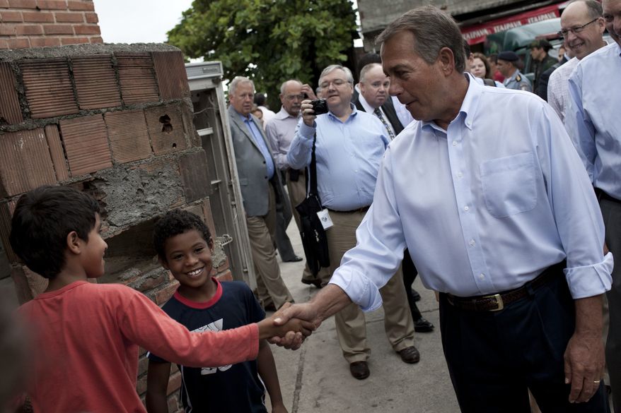 Speaker of the House Rep. John Boehner, R-Ohio, front right, shakes hands with a boy during a visit to the Vidigal slum in Rio de Janeiro, Brazil, Monday, Jan. 9, 2012. Boehner toured a Rio de Janeiro shantytown that has recently been taken over from drug traffickers by police. Boehner is leading a seven-member congressional delegation to Brazil, Colombia, and Mexico. (AP Photo/Felipe Dana)