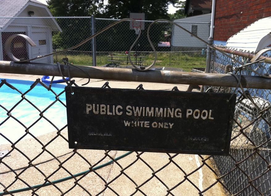 This June 9, 2011, photo provided by Michael Gunn shows a "white only" sign posted on the gate to a swimming pool at a duplex in Cincinnati where Mr. Gunn lived. (AP Photo/Michael Gunn)