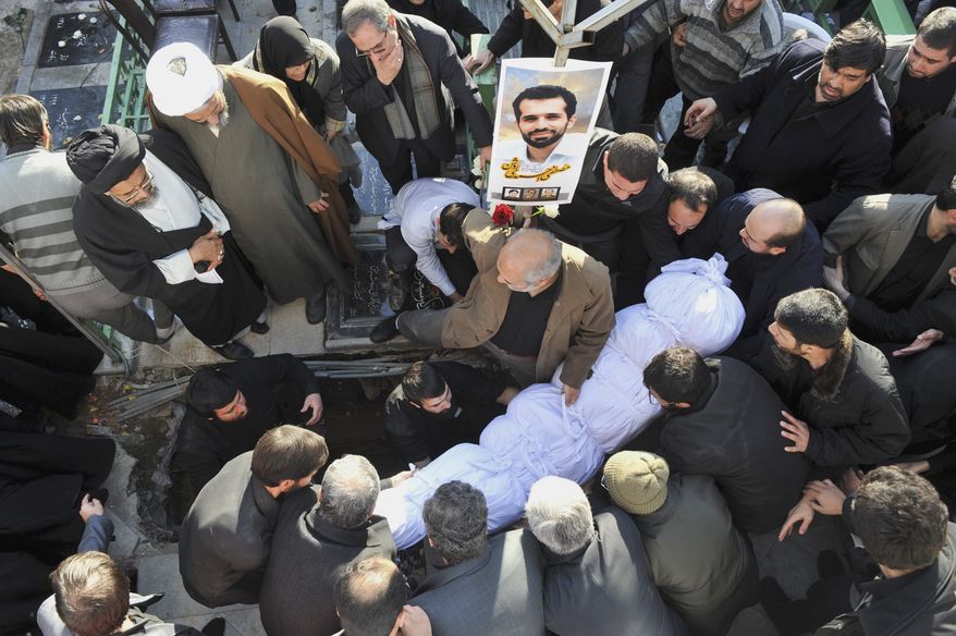 The shrouded body of Mostafa Ahmadi Roshan, a chemistry expert and a director of the Natanz uranium enrichment facility in central Iran, is seen prior to be buried in Tehran on Jan. 13, 2012. Roshan was killed two days earlier when two assailants on a motorcycle attached a magnetic bomb to his car. (Associated Press/Iranian Students News Agency)