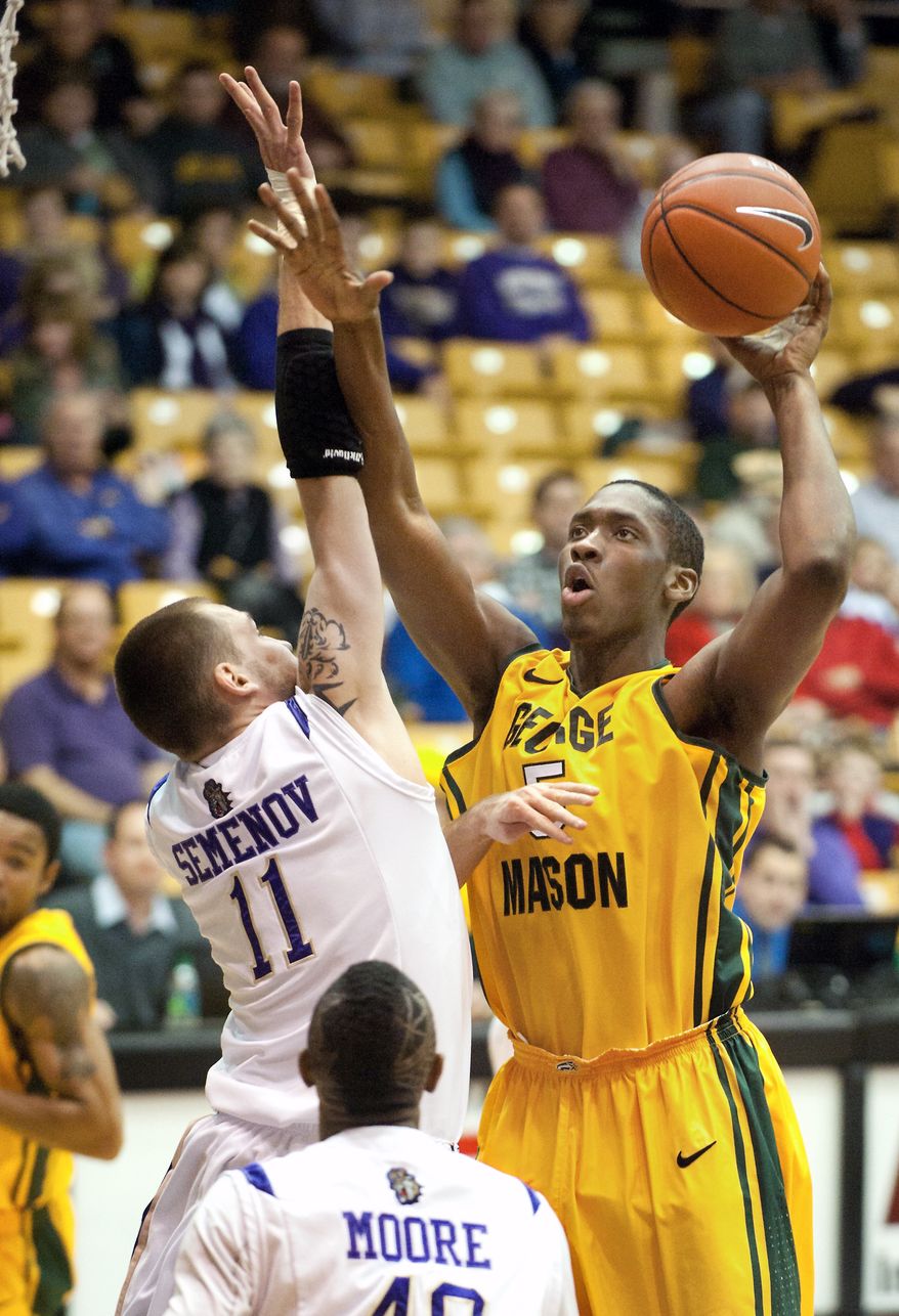 George Mason's Jonathan Arledge shoots over James Madison's Andrey Semenov in the second half Saturday, Jan. 14, 2012, in Harrisonburg, Va. He had 12 points and five rebounds in the 89-83 win. (AP Photo/The Daily News-Record, Michael Reilly)