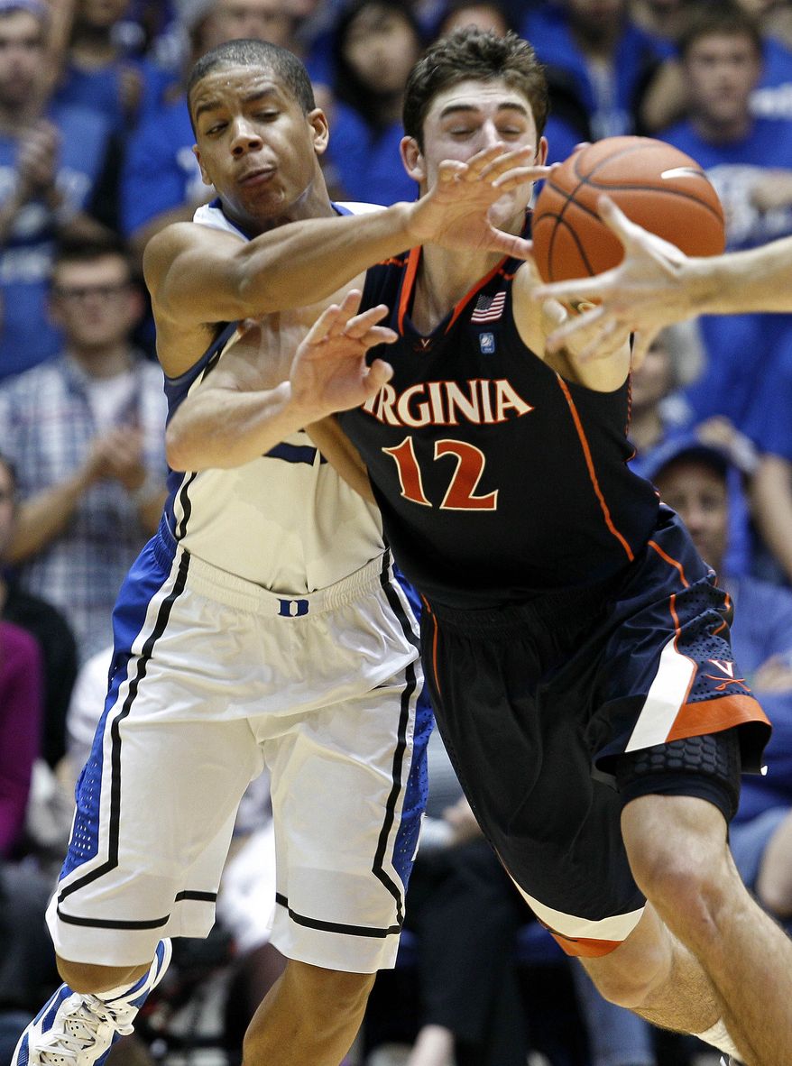 Duke's Andre Dawkins, left, and Virginia's Joe Harris chase a loose ball during the second half of in Durham, N.C., Thursday, Jan. 12, 2012. Duke won 61-58. (AP Photo/Gerry Broome)