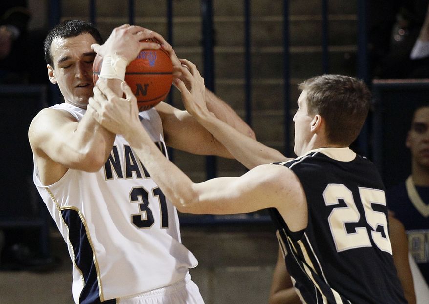 Navy forward J.J. Avila tries to keep the ball away from Army forward Whit Thornton in the second half in Annapolis, Md., Saturday, Jan. 14, 2012. Army won 75-62, despite a game-high 21 points from Avila. (AP Photo/Patrick Semansky)