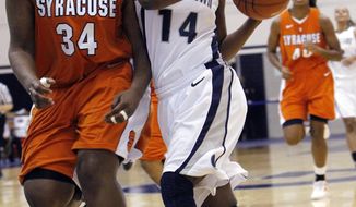 Georgetown guard Sugar Rodgers drives against Syracuse center Shakeya Leary during the second half of the game in Washington. Rodgers scored 21 points in Georgetown&#39;s 65-52 win on Saturday afternoon in Syracuse, N.Y. (AP Photo/Ann Heisenfelt)