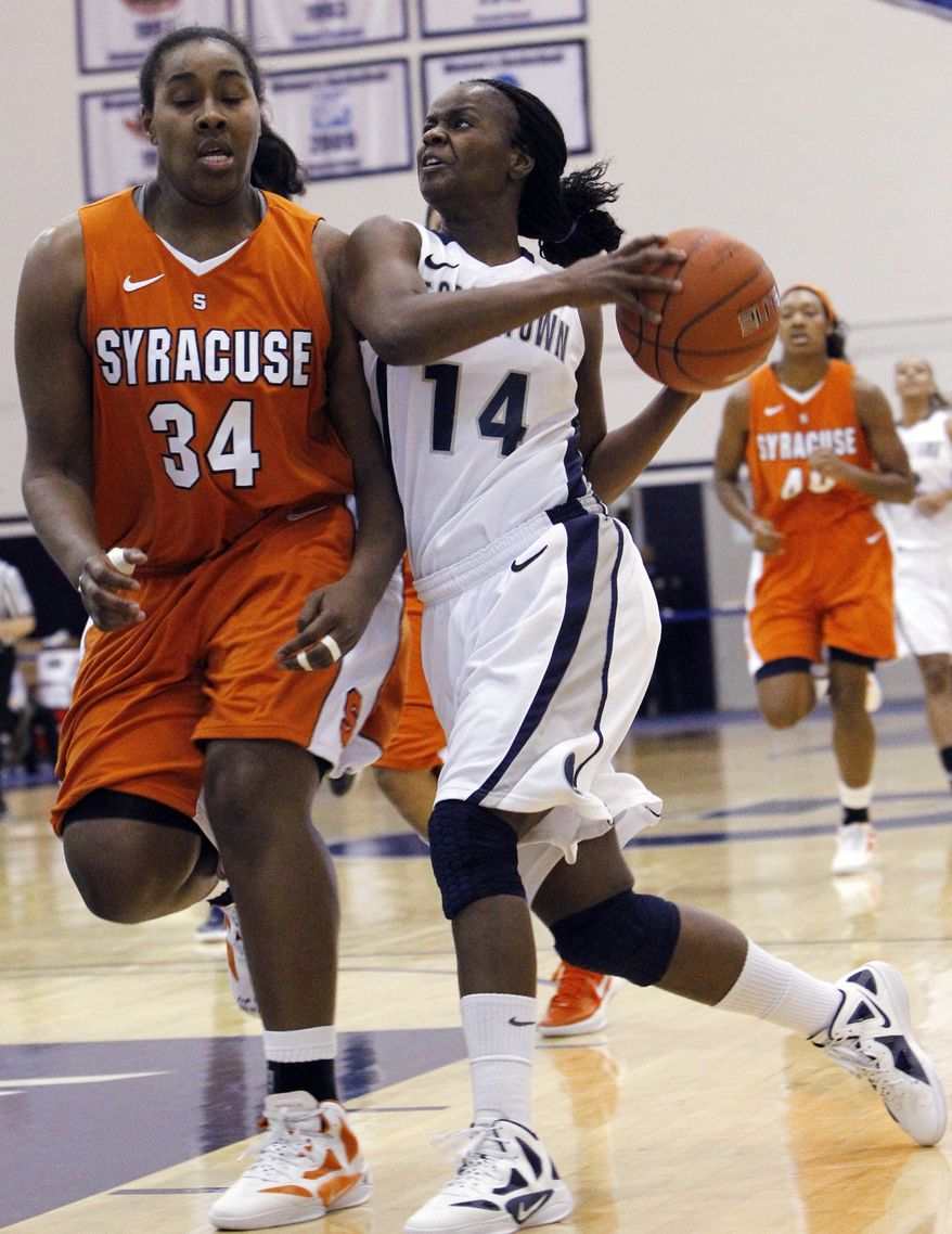 Georgetown guard Sugar Rodgers drives against Syracuse center Shakeya Leary during the second half of the game in Washington. Rodgers scored 21 points in Georgetown's 65-52 win on Saturday afternoon in Syracuse, N.Y. (AP Photo/Ann Heisenfelt)