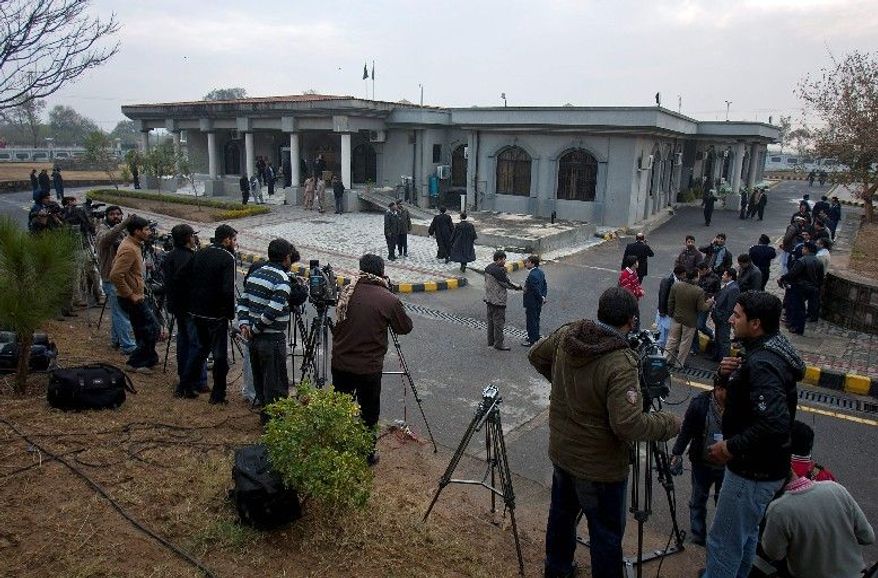 Pakistani media gather Monday in Islamabad, where a hearing of a judicial commission is in session. The Supreme Court set up the panel to investigate a secret-memo scandal in response to a petition filed by a group of opposition politicians. Prime Minister Yusuf Raza Gilani must appear Thursday to explain his refusal to cooperate in the probe. (Associated Press)