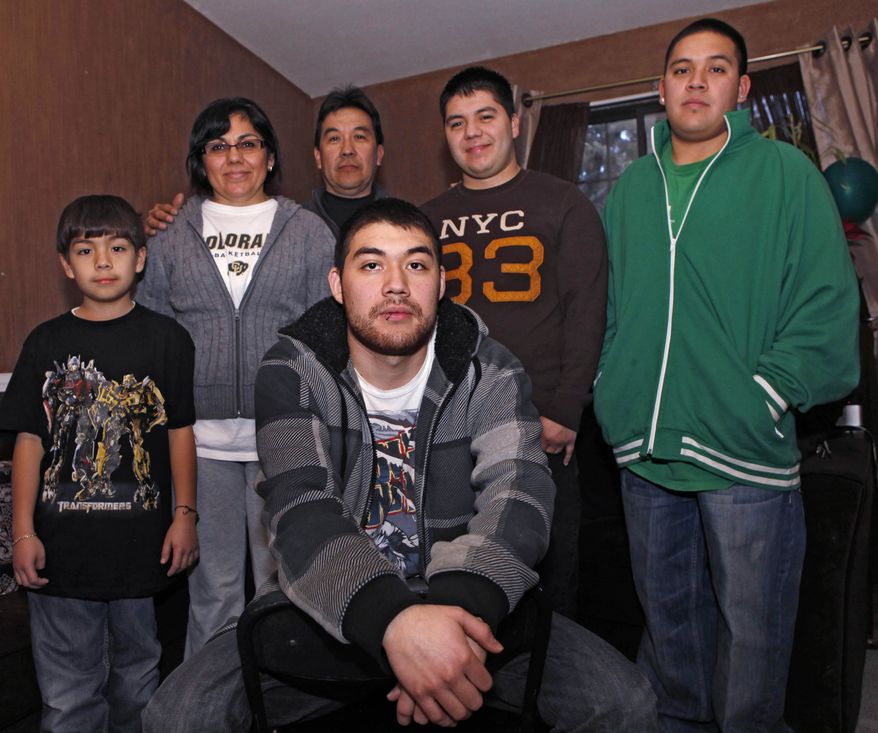 Jesus Gerardo Noriega (front) poses Jan. 4, 2012, with his parents and brothers at the family home in Aurora, Colo. Jesus, 21, faced deportation last year after he was arrested for driving with no license plate light. Noriega's family brought him to the United States from Mexico when he was 9. (Associated Press)