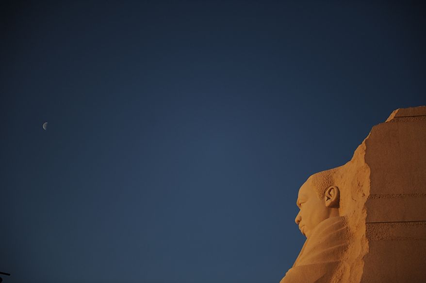 The moon is seen in the sky above the Martin Luther King Jr. Memorial on the National Mall in Washington on Monday, Jan. 16, 2012. (Rod Lamkey Jr./The Washington Times)