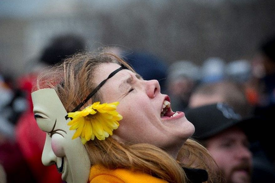 Amy Payne of Martinsville, Va., joins the hundreds who gathered at the Capitol in singing the National Anthem, (Rod Lamkey Jr./The Washington Times)