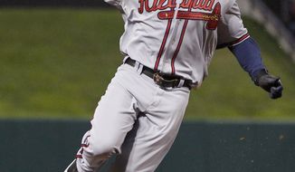 ** FILE ** In this Sept. 9, 2011, file photo, Atlanta Braves&#x27; Michael Bourn rounds third on a double by Brian McCann during the first inning of a baseball game against the St. Louis Cardinals in St. Louis. (AP Photo/Jeff Roberson, File)
