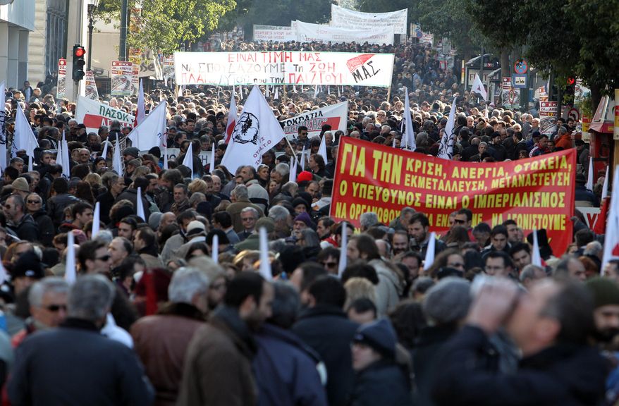 Demonstrators carrying banners with anti-austerity slogans protest during a rally organized by the PAME Communist-affiliated union on Tuesday, Jan. 17, 2012, in Athens. (AP Photo/Thanassis Stavrakis)