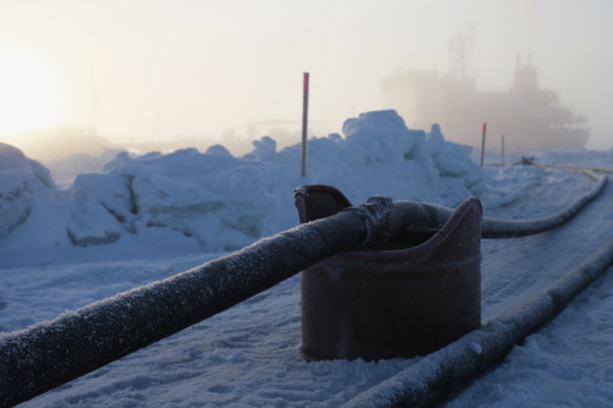 Two hose lines — one for gasoline, the other for diesel fuel — run from the Russian tanker Renda to the shoreline as workers prepare for pressure tests on Monday, Jan. 16, 2012, in Nome, Alaska. (AP Photo/U.S. Coast Guard, Petty Officer 2nd Class Eric J. Chandler)
