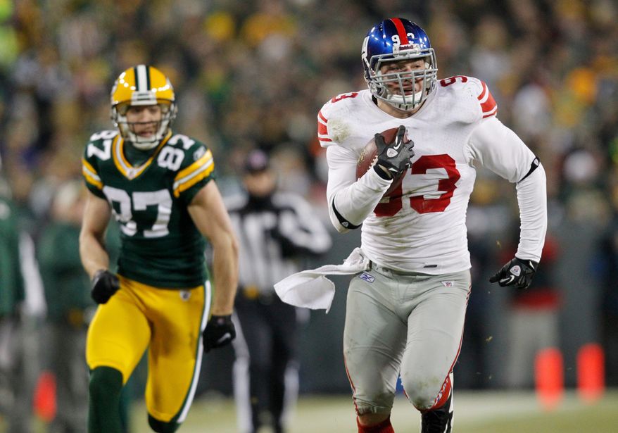 New York linebacker Chase Blackburn returns a fumble against Green Bay in their NFC playoff game last Sunday. He didn't play his first game this season until Dec. 4. (Associted Press)