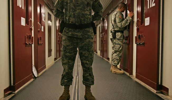 ** FILE ** Military personnel inspect each occupied cell on a two-minute cycle at the Camp 5 maximum-security facility at the U.S. Naval Base at Guantanamo Bay, Cuba, in October 2007. (AP Photo/Brennan Linsley, File)