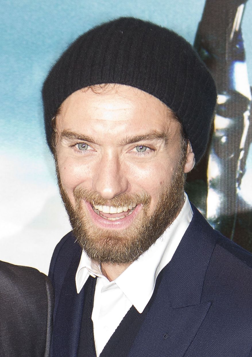 **FILE** Actor Jude Law poses for photographers Dec. 8, 2011, at the European premiere of "Sherlock Holmes: A Game of Shadows" at a central London cinema. (Associated Press)