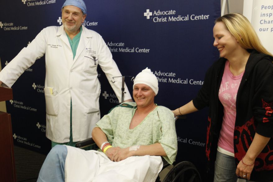 Neurosurgeon Leslie Schaffer, left, smiles with his patient Dante Autullo, and Dante's fiance, Gail Glaenzer, during a news conference at Advocate Christ Medical Center Friday, Jan. 20, 2012, in Oak Lawn, Ill. The trio spoke a day after Autullo underwent surgery to remove a 3 1/4-inch nail lodged in his brain after accidentally shooting himself with a nail gun. (AP Photo/M. Spencer Green)