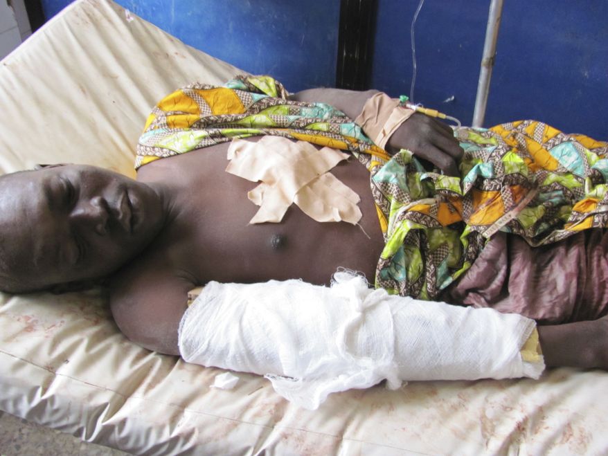 A victim of Friday's bomb blast and gun attacks lies in Murtala Muhammad specialist hospital in Kano, Nigeria Saturday, Jan. 21, 2012. Coordinated attacks claimed by a radical Islamist sect killed at least 120 people in north Nigeria's largest city, hospital records seen Saturday show, as gunfire still echoed around some areas of the sprawling city. (AP Photo/Salisu Rabiu)