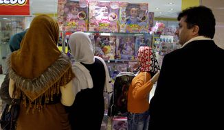 Iranians look at a doll display in a toy shop in Tehran on Friday. Police have closed down dozens of toy shops for selling Barbie dolls, part of a decades-long crackdown on signs of Western culture in Iran. (Associated Press)