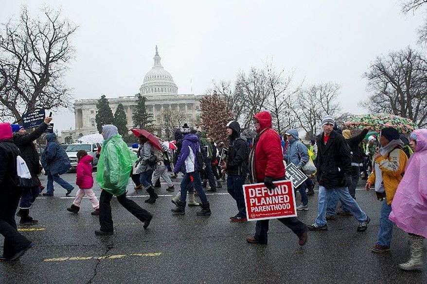** FILE ** In this Jan. 23, 2012, file photo, pro-life advocates march past the Capitol during the annual March for Life in Washington, D.C. (Barbara L. Salisbury/The Washington Times)