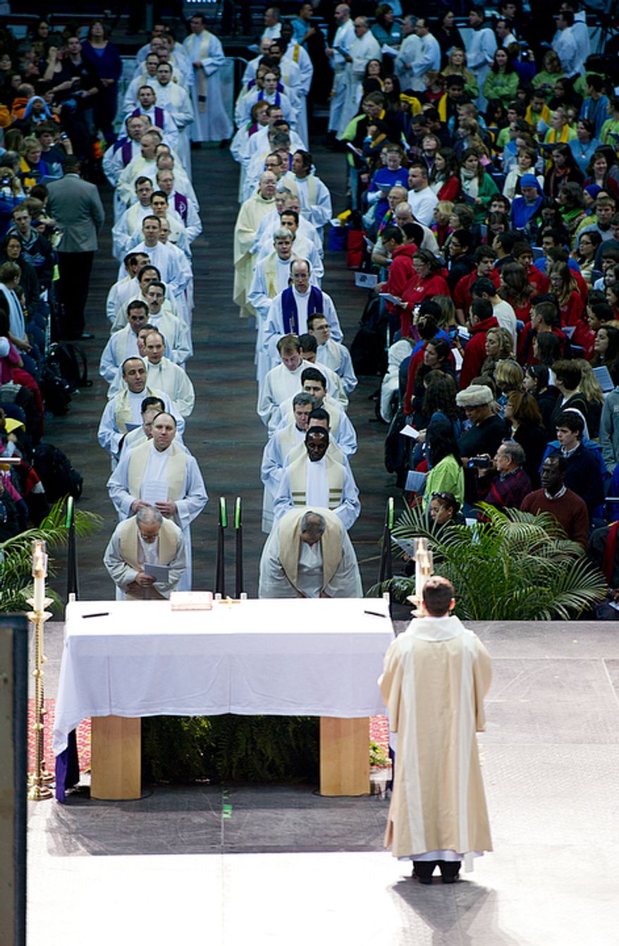 Priests, bishops and cardinals process up the long aisle at the Verizon Center for the Catholic mass that was part of the Youth Rally and Mass for Life. About 15,500 people were expected, with an additional 10,000 at the D.C. Armory. (Barbara L. Salisbury/The Washington Times)