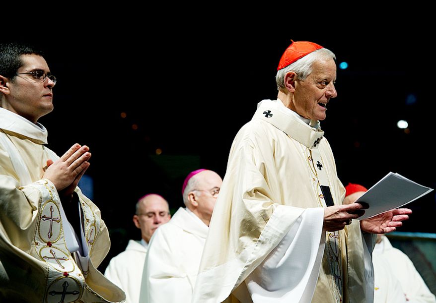 Donald Wuerl, right, archbishop of Washington, presides over the Catholic mass at the Verizon Center, part of the Youth Rally and Mass for Life. Thousands of people attended the event and then marched to the Supreme Court demanding that Roe v. Wade be overturned. (Barbara L. Salisbury/The Washington Times)