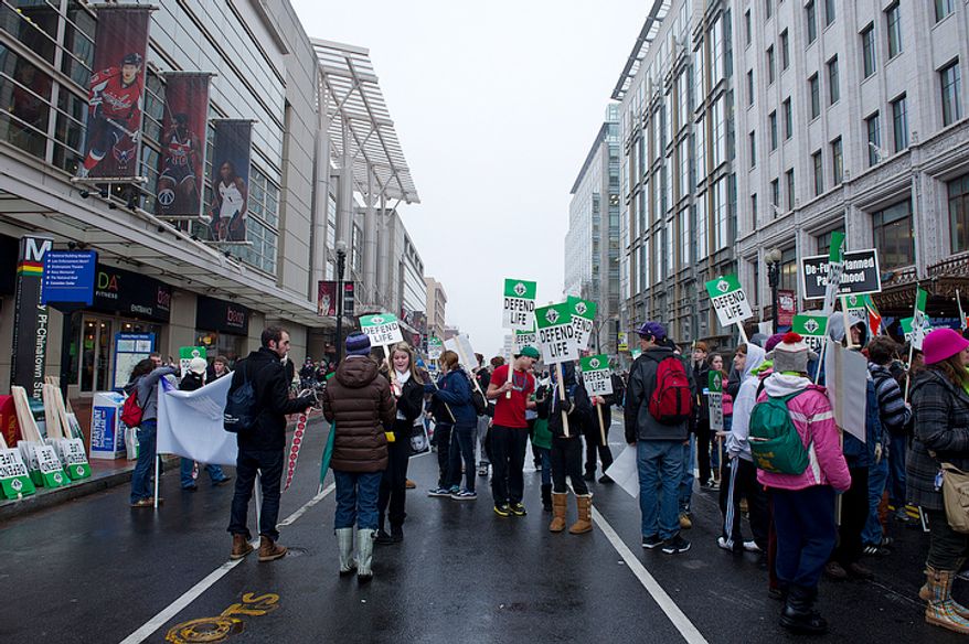 Hundreds of youths gather in the street outside the Verizon Center in Washington, D.C., on Monday, Jan. 23, 2012 following the Youth Rally and Mass for Life. Once the mass was completed, people picked up signs and prepared to march to the Supreme Court in defense of pro-life legislation. (Barbara L. Salisbury/The Washington Times)